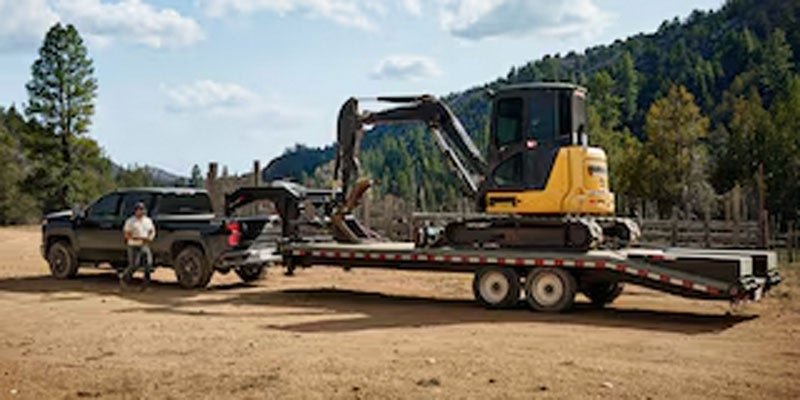 A 2026 Chevrolet Silverado 2500 HD in Northampton, MA towing heavy machinery.