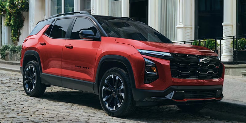 Red Chevrolet Equinox SUV driving on road