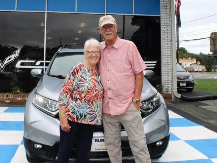 A_old_age_couple_standing_in_front-of-Burke-chevrolet-vehicle